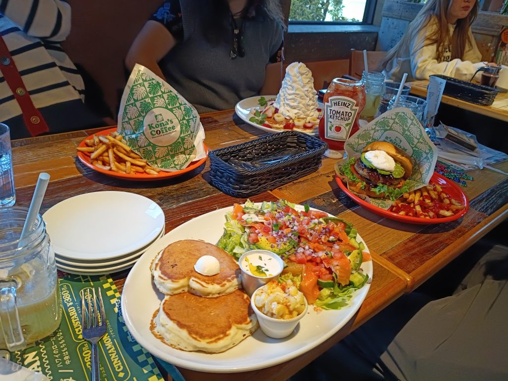 Table with food, burgers, pancakes and fries
